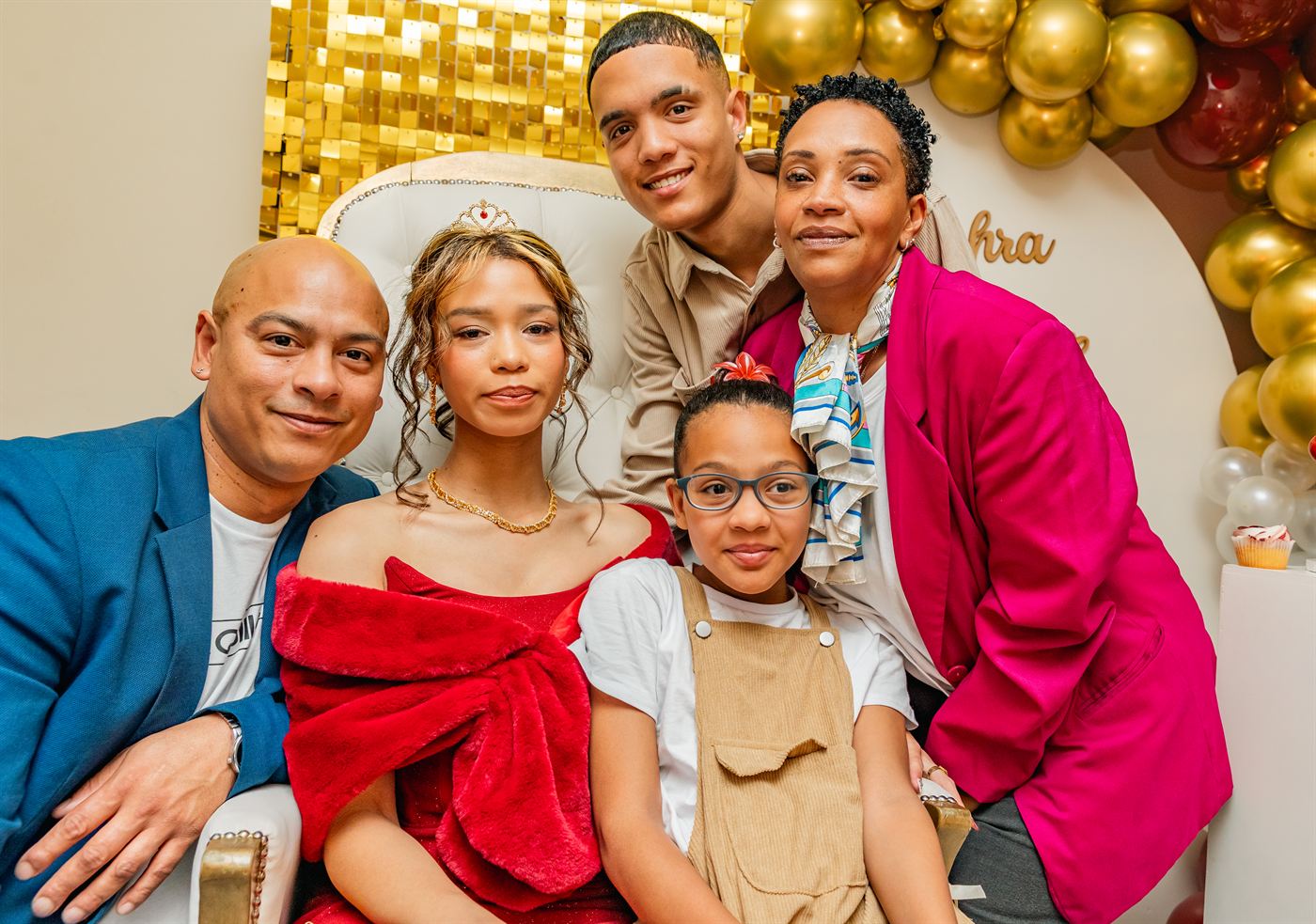 Family gathered around a young woman before her matric farewell
