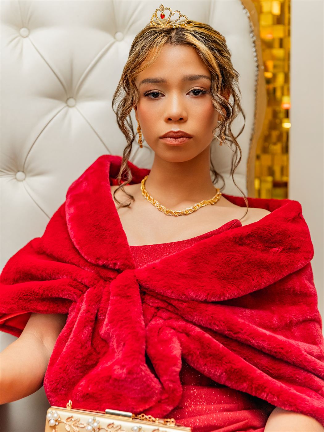 Close portrait of a young woman in a red velvet gown and fur stole